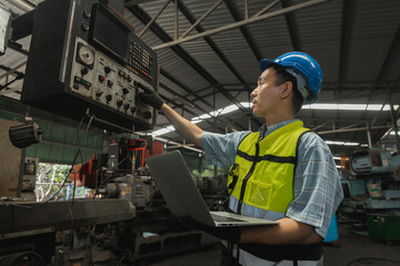 Asian engineer working and control industry machine