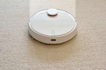 Robot vacuum cleaner cleans a dirty carpet