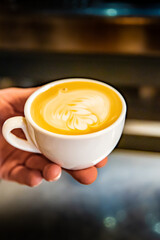 Barista hand making cappuccino Coffee with espresso and milk in cafe