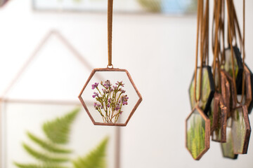 An amulet with a dry flower bouquet behind glass for harmony and protection. Handmade work.