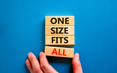 One size fits all symbol. Concept words One size fits all on wooden blocks. Businessman hand....