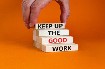 Keep up the good work symbol. Concept words Keep up the good work on wooden blocks. Businessman hand. Beautiful orange table orange background. Keep up the good work business concept. Copy space.