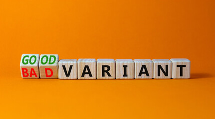 Good or bad variant symbol. Turned wooden cubes and changed words bad variant to good variant. Beautiful orange table orange background. Business good or bad variant concept, copy space.