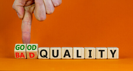 Good or bad quality symbol. Businessman turns cubes and changes words bad quality to good quality....