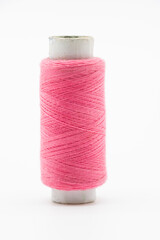 single pink color  yarn or spool thread  over on background