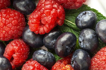 Assortment of red fruits, strawberries, blueberries and raspberries, close up