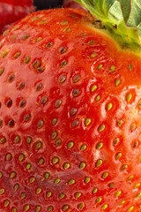 Assortment of red fruits, strawberries, blueberries and raspberries, close up