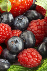 Assortment of red fruits, strawberries, blueberries and raspberries, close up