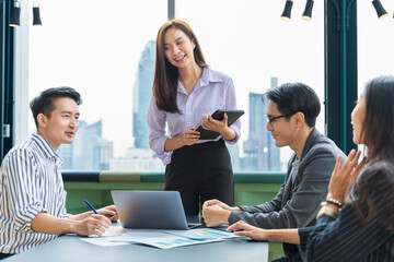 Team of young Asian entrepreneur have small team meeting for upcoming project for marketing and sale management with skyscraper view for business startup and education concept
