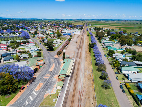 aerial view of singleton train station with empty carparking facilities and railway track