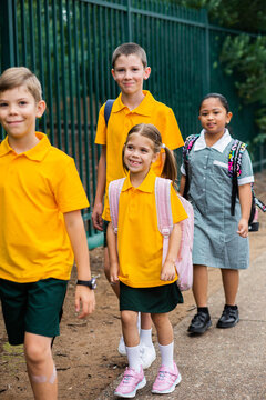 Group Of Happy Kids Walking To School Together