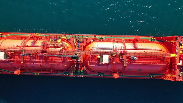 Aerial drone top down pan video of industrial LPG gas tanker ship anchored in Mediterranean deep blue sea