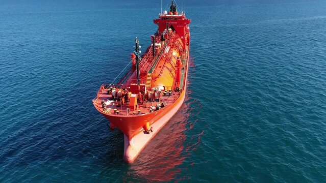 Aerial drone video of industrial LPG gas tanker ship anchored in Mediterranean deep blue sea