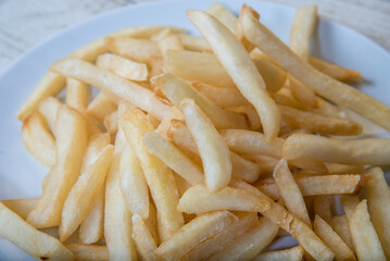 French Fries Asian street food in a white plate on the wooden floor French Fries, BBQ Sauce, Tomato Soy Sauce