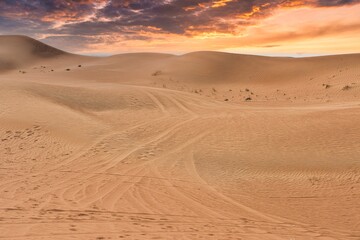 Fototapeta na wymiar Sand dunes landscape view of Sahara desert at sunset in Dubai, United Arab Emirates