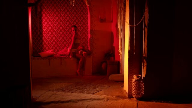 seduction by exotic oriental dance, stunning woman is moving in room of palace