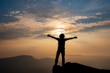 Fototapeta premium silhouette of person with arms outstretched