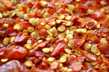 close up of red chili flakes on table 