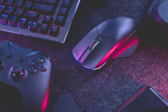 gamer work space concept, top view a gaming gear, mouse, keyboard, joystick, headset with rgb color