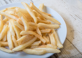 French Fries Asian street food in a white plate on the wooden floor French Fries, BBQ Sauce, Tomato Soy Sauce