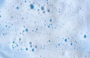 Soap cleanser foam bubbles texture on blue background - obrazy, fototapety, plakaty