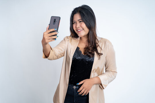 young woman make a video call using mobile phone on isolated background