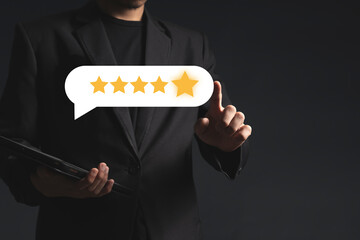 close up on customer man hand pressing on screen with gold five star rating feedback icon