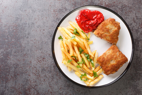Typical Spanish gastronomy cachopo de ternera closeup in the white plate on the table. Horizontal top view from above