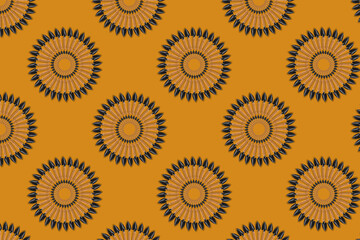 Abstract seamless pattern, the element is taken from a real photo. The ornament is colored, consists of small garden shovels in the shape of a circle on an orange background. Concept: print on fabric.