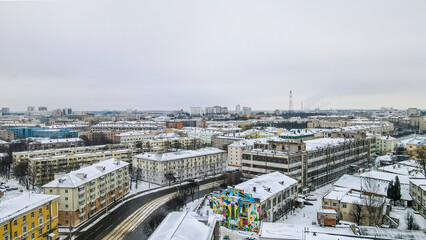 Obraz premium Beautiful top view of cityscape with tv tower, ferris wheels, factory and buildings in winter.