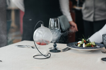 An exquisite salad of seafood, tuna and black caviar in a beautiful serving on the table in the restaurant. Exquisite delicacies of haute cuisine close-up