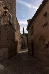 Fototapeta na wymiar old cobbled street in the medieval town of pals on the costa brava