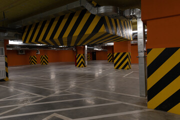 Underground parking in a mall, soft focus. Empty mall underground parking lot or garage interior...