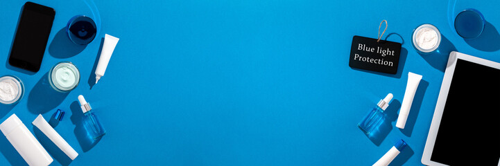 Skin care cosmetics protecting from gadgets blue light on blue background, web banner