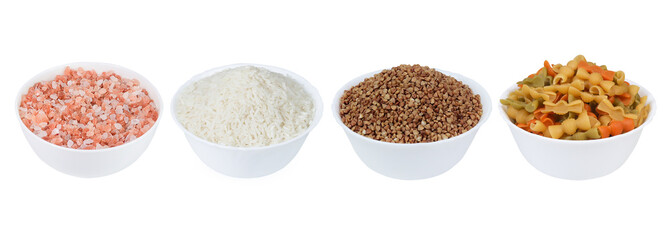 Himalayan salt, multicolored pasta, rice and buckwheat on an isolated white background. Cereals and salt. Set of cereals and salt in a white bowl