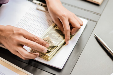 Business woman hands counting us dollar banknotes in the office