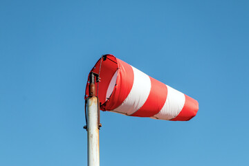 Windsock in windy weather against a blue sky