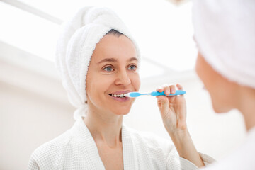 Happy Lady Brushing Teeth With Toothbrush Standing In Bathroom Indoor