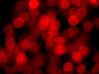 Abstract blur image of red light of night party bokeh on dark background. Blurred festive and celebration bokeh background.
