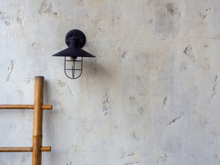 Empty space of white concrete wall texture background decoration with wall lamp and wooden bamboo ladder.