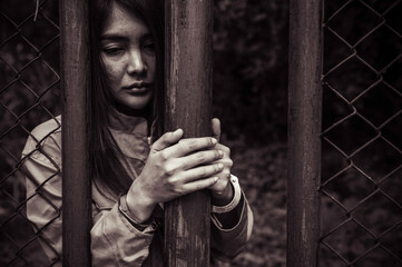 Portrait of women desperate to catch the iron prison,prisoner concept,thailand people,Hope to be...