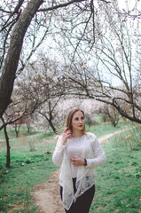 beautiful girl model in spring garden in flowers