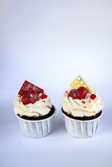 chocolate cupcakes with cream cheese frosting and festive decor. Valentine's day or birthday dessert. Beautiful festive food for a wedding or children's party.