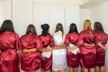Bride and godmothers together with their backs to the camera.