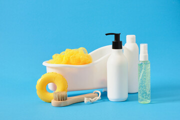 body care products in mockup bottles, washcloth and massage brush in a toy bath