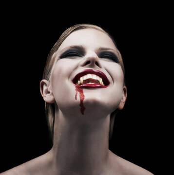 Satisfying her craving. A provocative female vampire feeling intense pleasure after feeding.