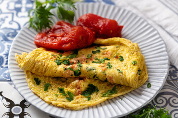 scrambled eggs, scrambled eggs with flour and milk with tomatoes and herbs, traditional breakfast, close-up