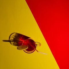 A fresh red beverage on red yellow background