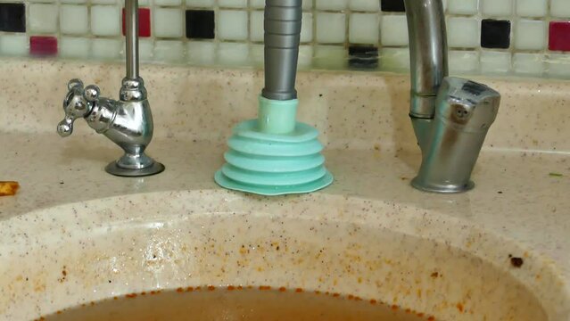 clogging in the kitchen sink-dirty dishwater accumulated in the sink