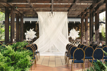 Arch for the wedding ceremony, decorated with fabric and flowers